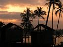 Sunrise over beach huts.